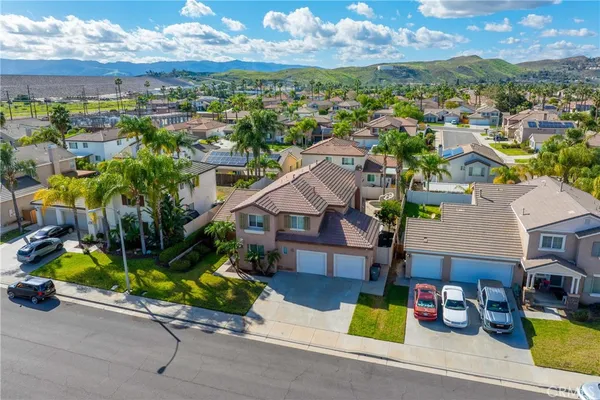 an aerial view of residential houses with outdoor space and parking