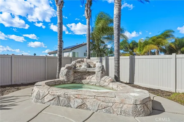 a view of an empty room with wooden floor and windows