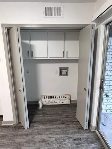 a view of a closet with wooden floor