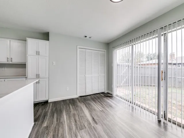 a view of a kitchen with wooden floor and a sink