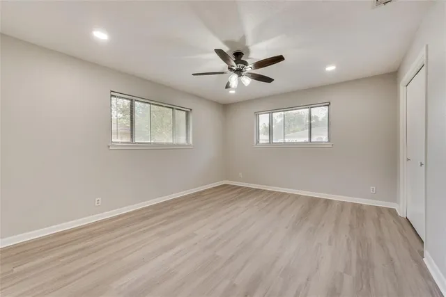 wooden floor in an empty room with a window