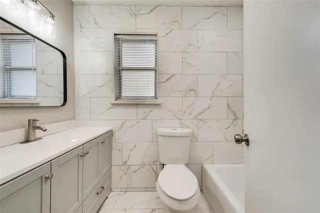 a bathroom with a sink a toilet and mirror