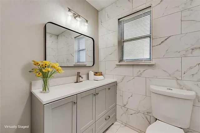 a bathroom with a sink toilet and mirror