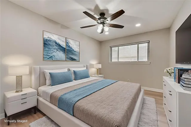 a bedroom with a large bed and a chandelier