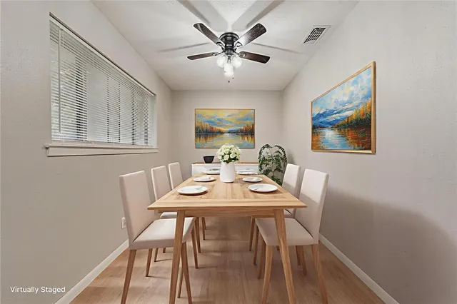 a view of a dining room with furniture and wooden floor