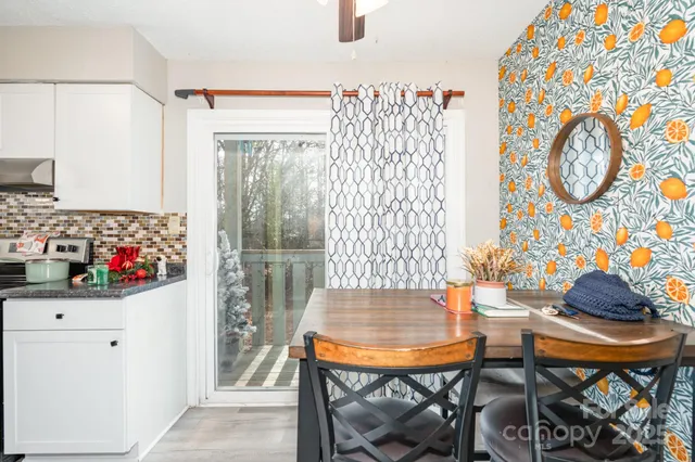 a view of a room that has a table and a chair in it