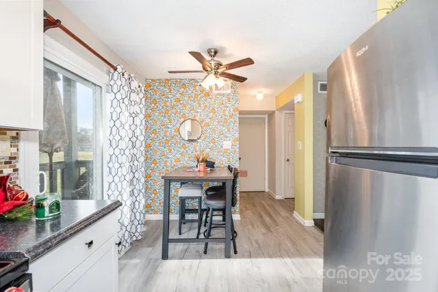 a view of a kitchen with a table and chairs