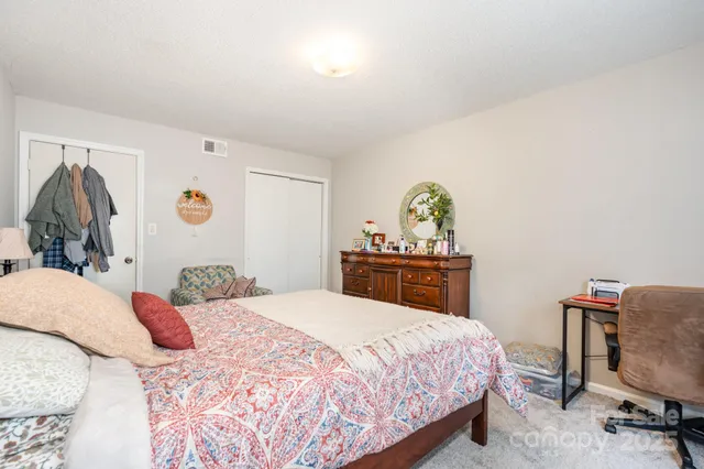 a bedroom with a bed and a desk