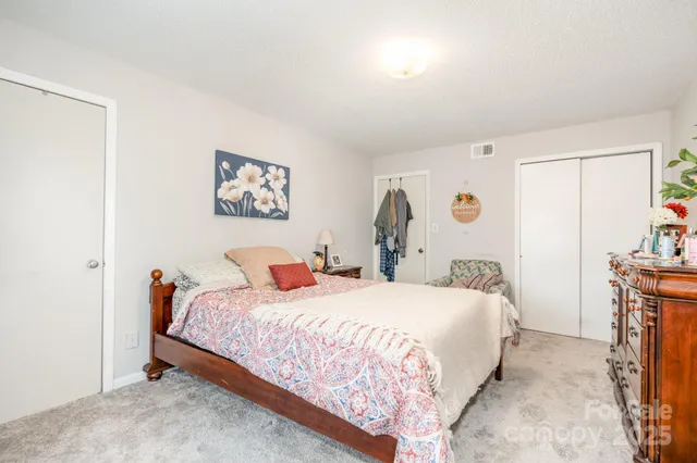 a bedroom with a bed and a table in it