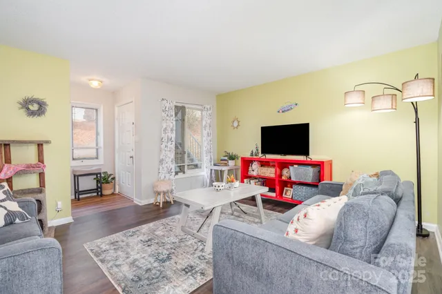 a living room with furniture and a flat screen tv