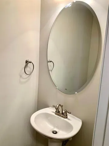 a bathroom with a sink and mirror