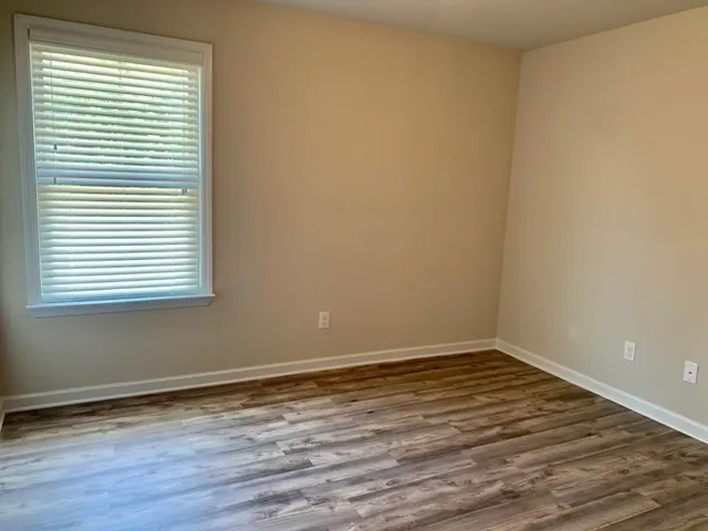 a view of a room with wooden floor and a window