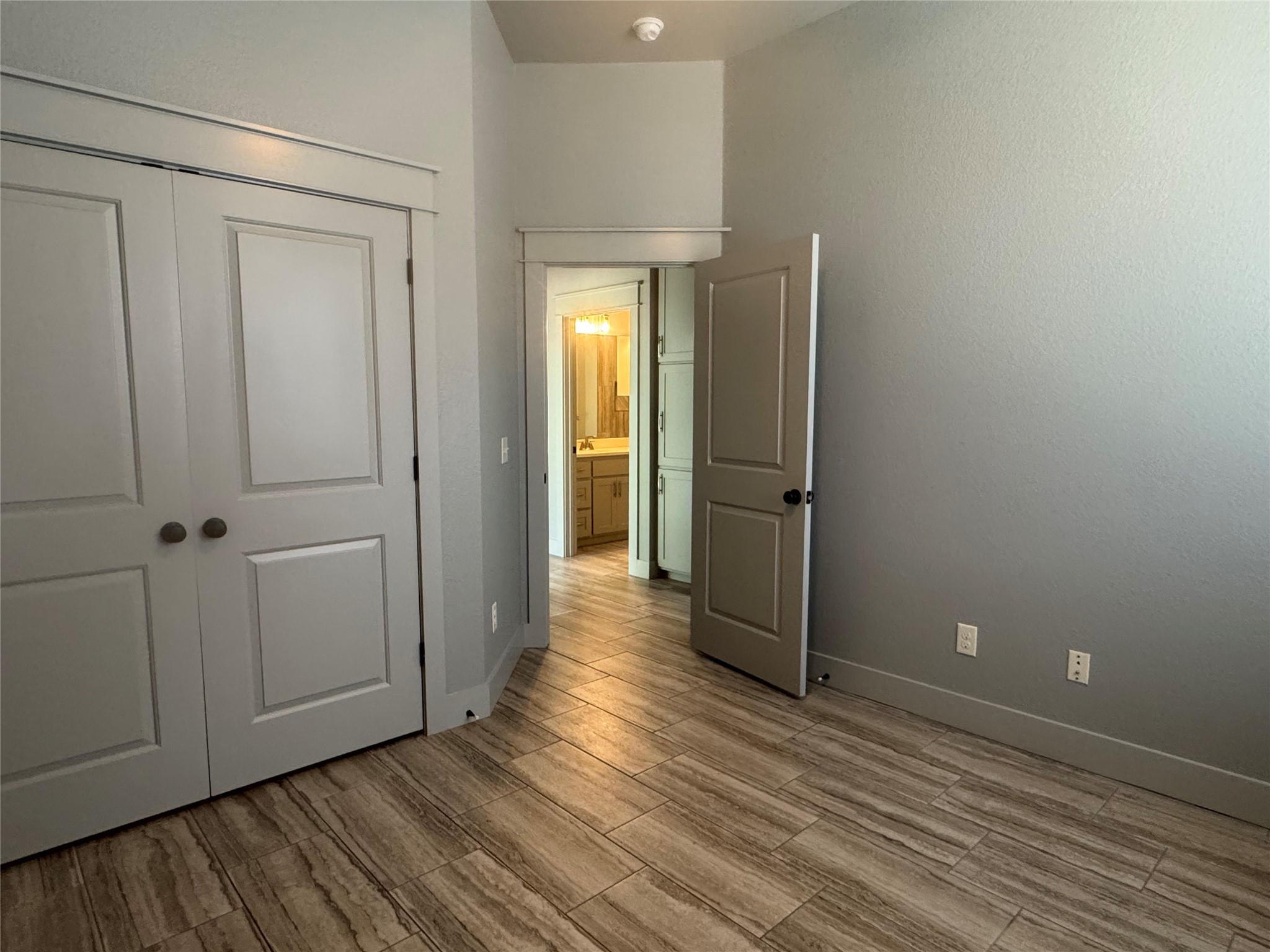 290 Hugo Road, Unit B San Marcos, TX 78666 - Photo 15 of 22 a view of a livingroom with wooden floor and a hallway