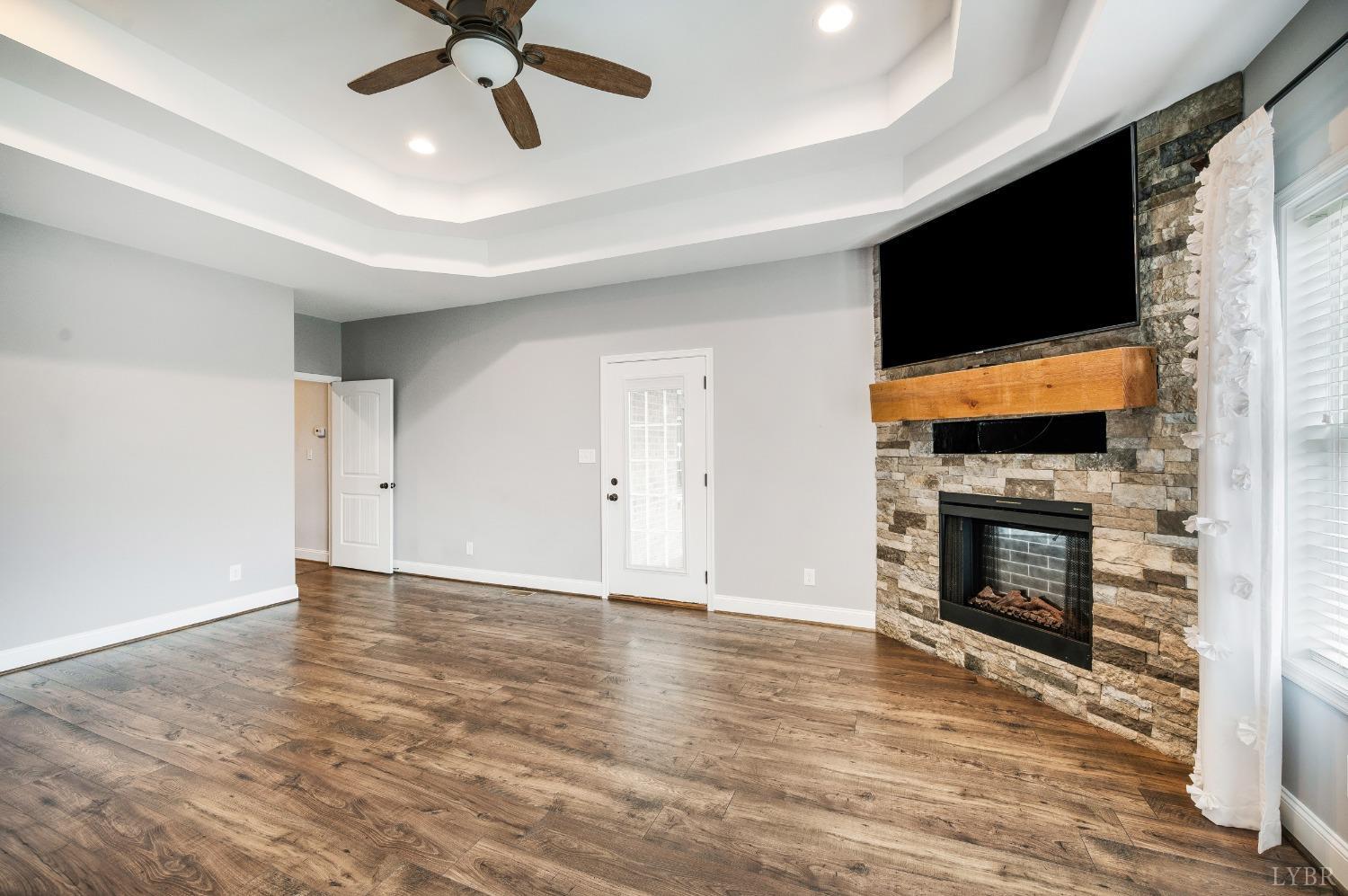 1695 Colby Drive Forest, VA 24551 - Photo 35 of 92 a view of an empty room with wooden floor fireplace and a window