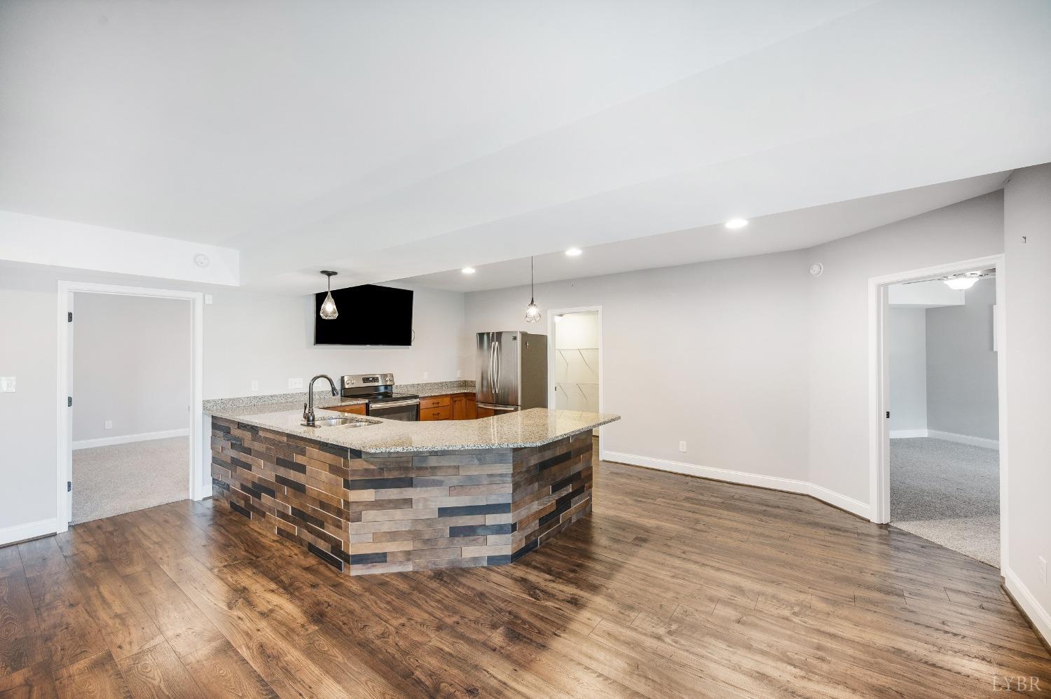 1695 Colby Drive Forest, VA 24551 - Photo 66 of 92 a room with wooden floor and flat screen tv