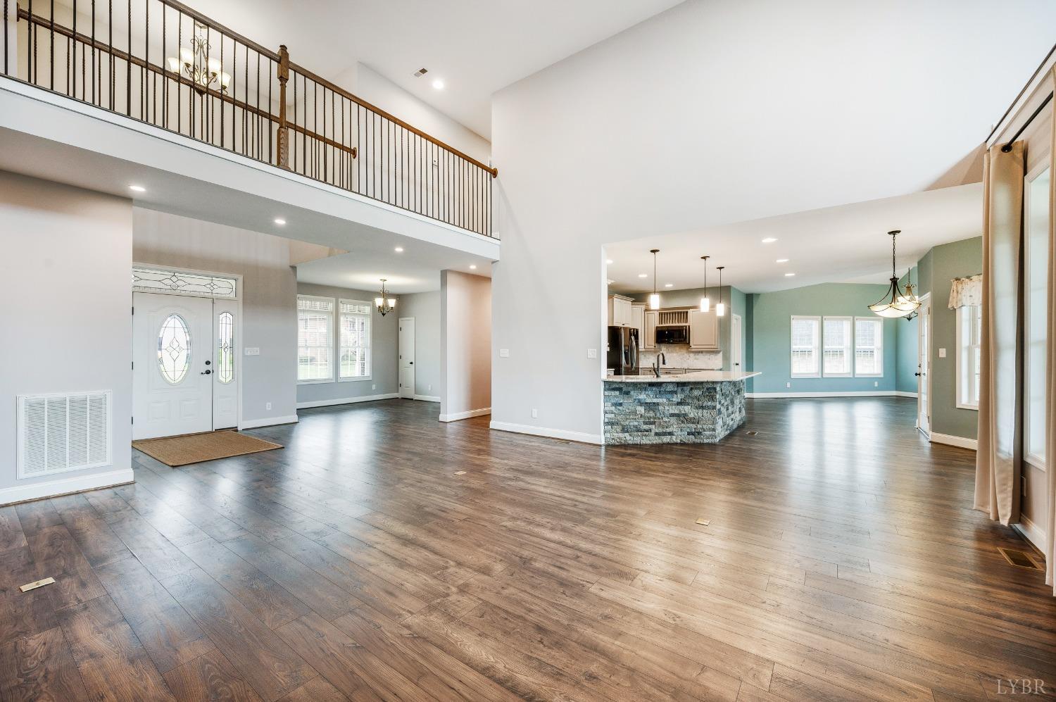 1695 Colby Drive Forest, VA 24551 - Photo 7 of 92 a view of a hallway with wooden floor and a kitchen