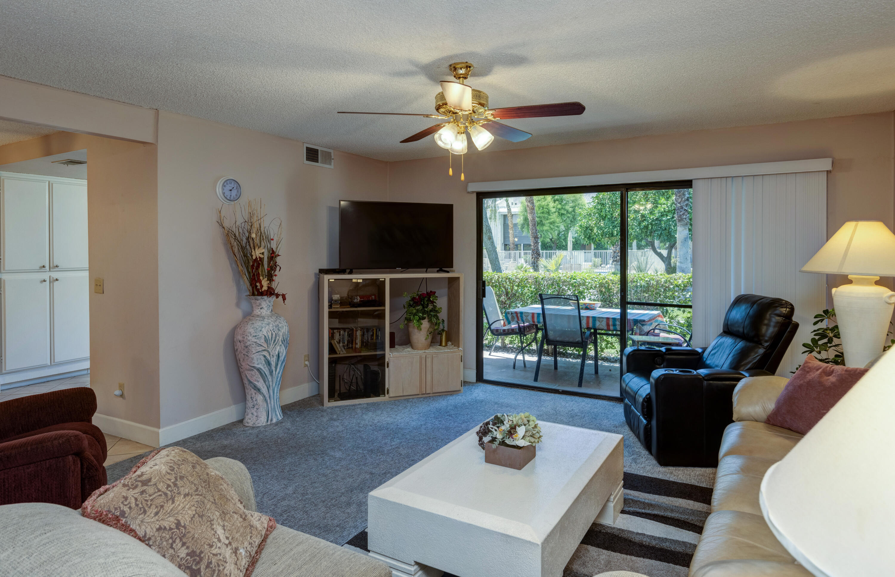 3155 Ramon Road, Unit 503 Palm Springs, CA 92264 - Photo 2 of 21 a living room with furniture a window and a flat screen tv
