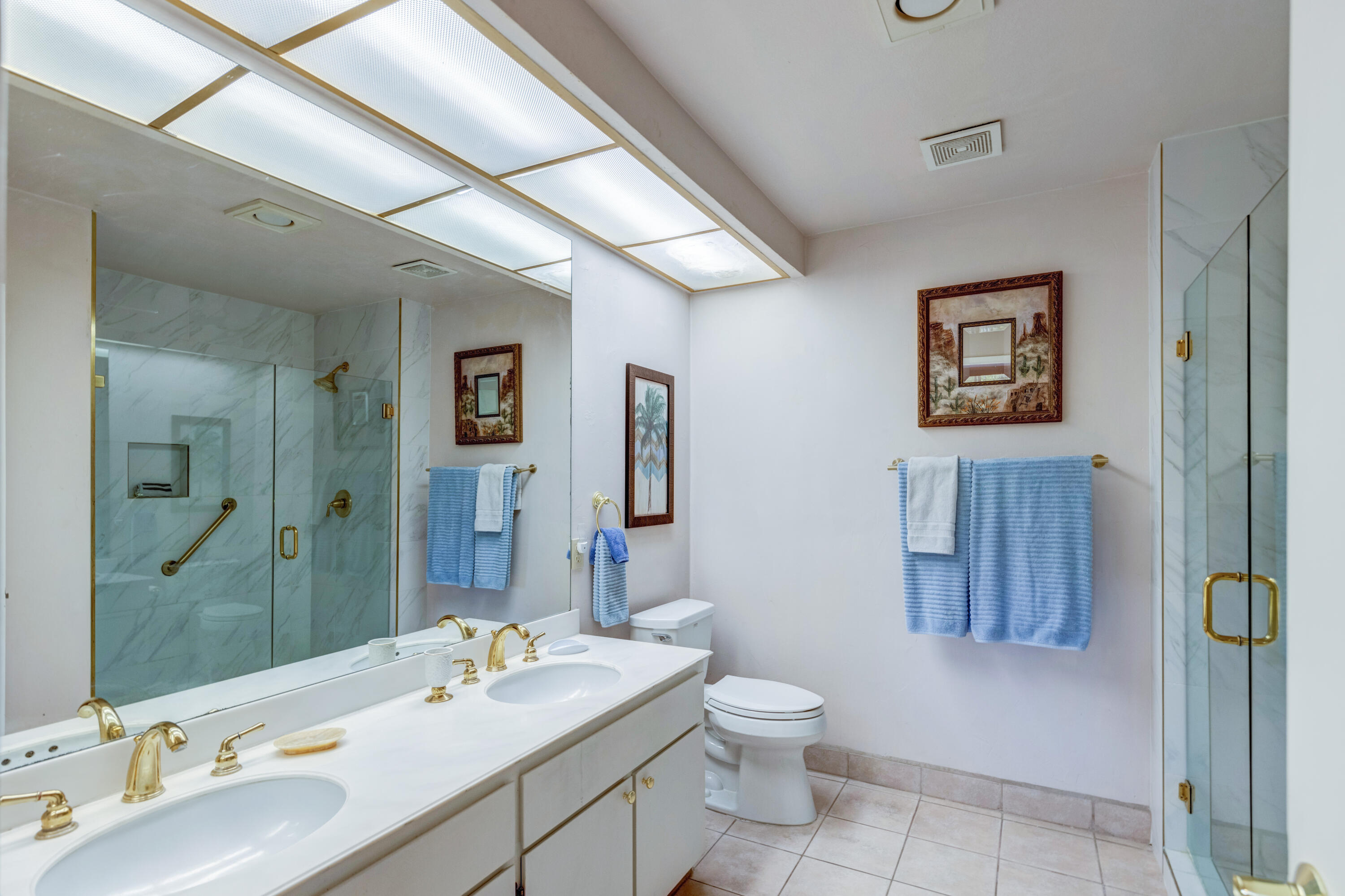 3155 Ramon Road, Unit 503 Palm Springs, CA 92264 - Photo 12 of 21 a bathroom with a toilet sink and mirror