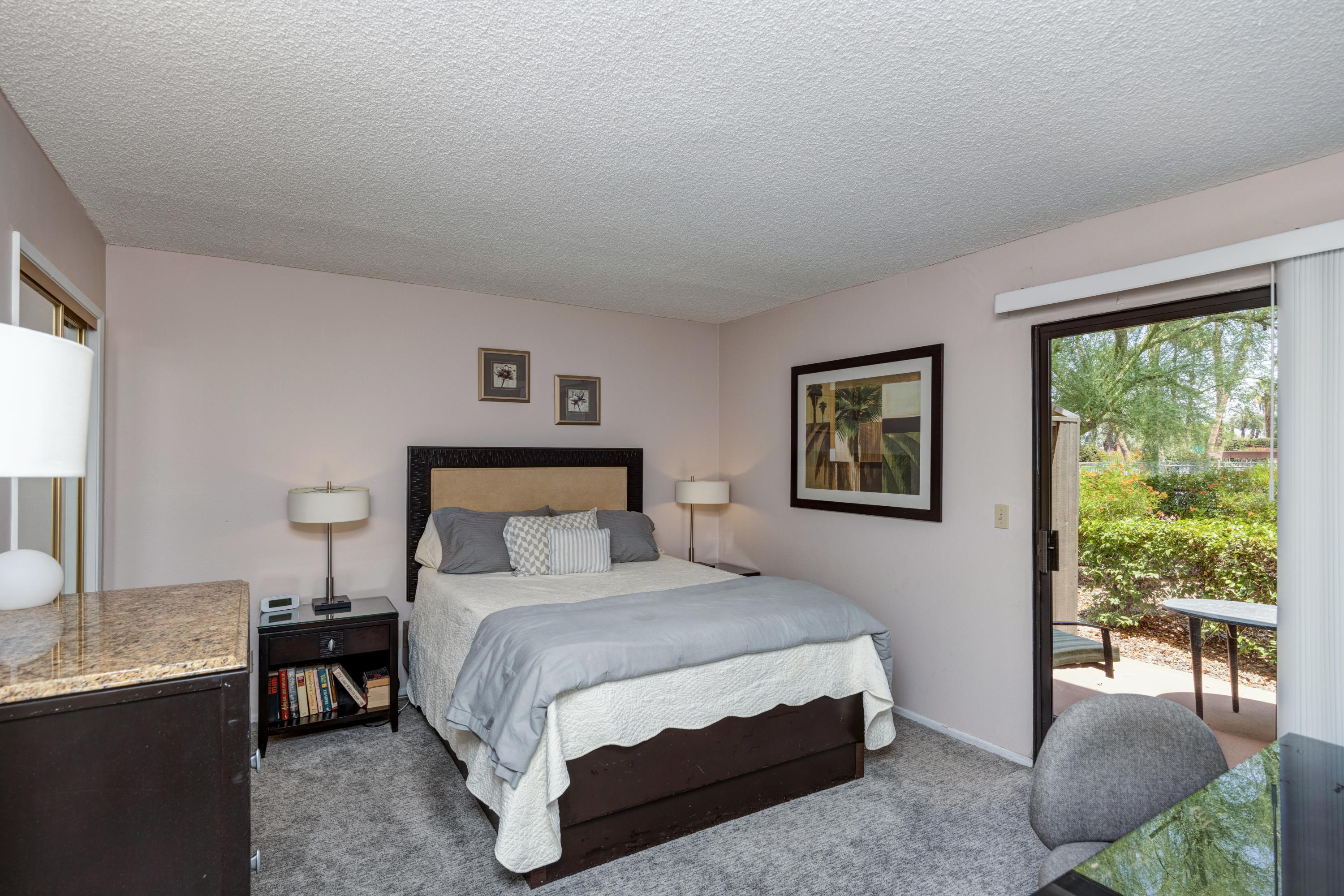 3155 Ramon Road, Unit 503 Palm Springs, CA 92264 - Photo 14 of 21 a bedroom with a bed and a table