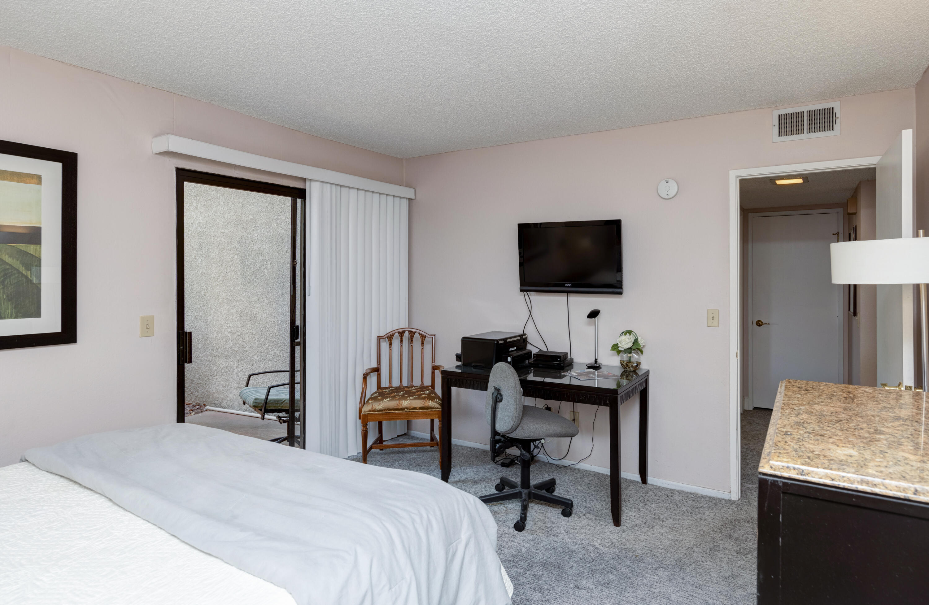 3155 Ramon Road, Unit 503 Palm Springs, CA 92264 - Photo 15 of 21 a bedroom with a workspace