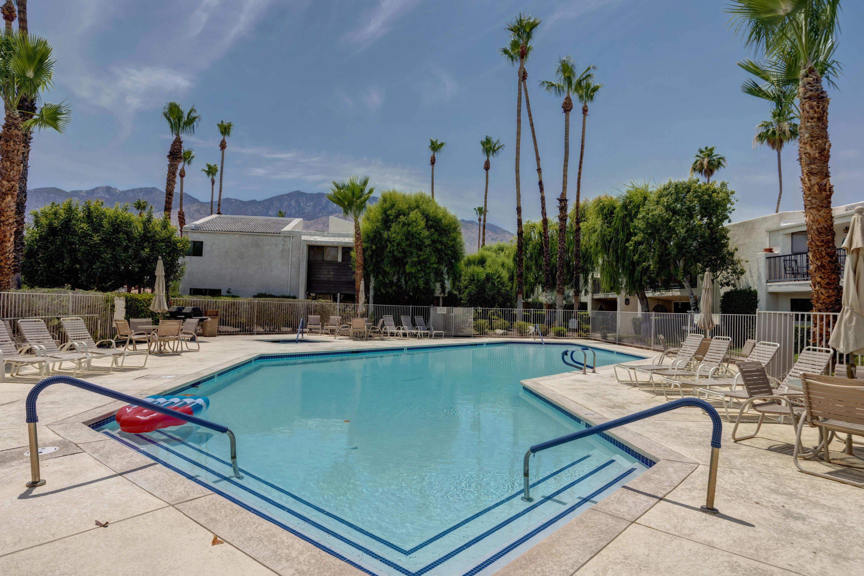 3155 Ramon Road, Unit 503 Palm Springs, CA 92264 - Photo 19 of 21 a view of a swimming pool with chairs