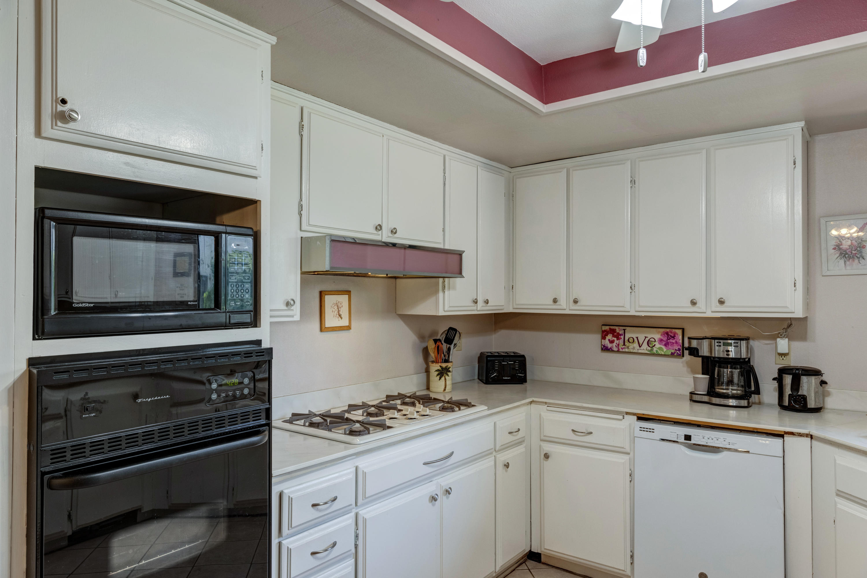 3155 Ramon Road, Unit 503 Palm Springs, CA 92264 - Photo 7 of 21 a kitchen with stainless steel appliances granite countertop a stove microwave and cabinets