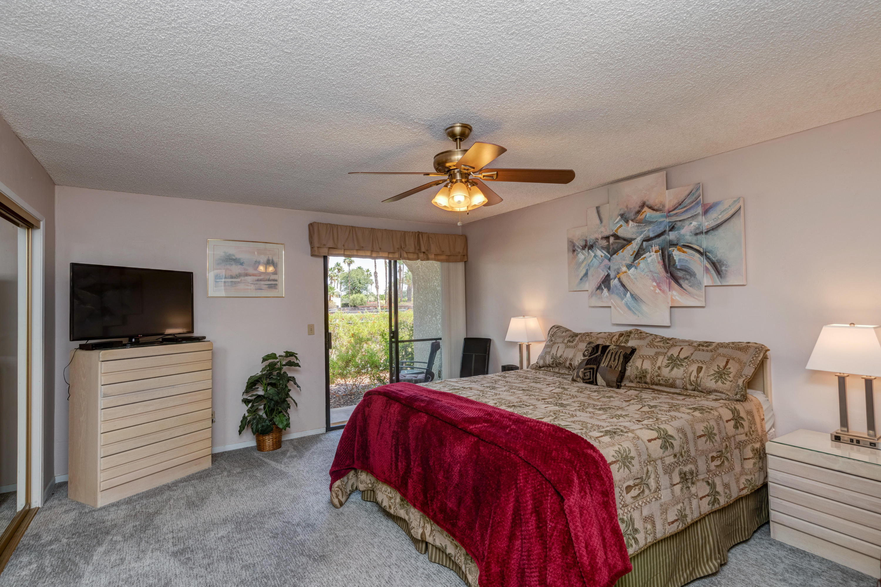 3155 Ramon Road, Unit 503 Palm Springs, CA 92264 - Photo 10 of 21 a bedroom with a bed and a flat screen tv