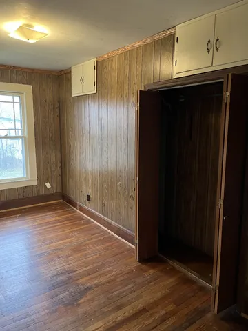 an empty room with wooden floor