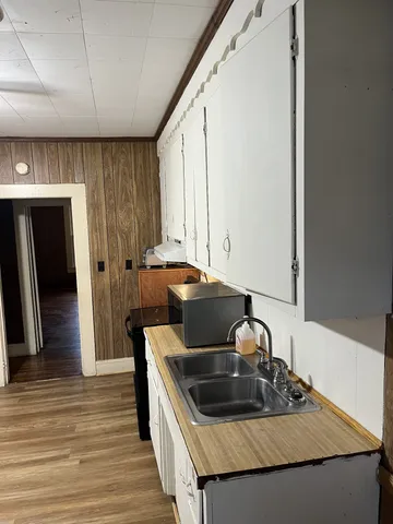 a kitchen with granite countertop a sink and a stove top oven