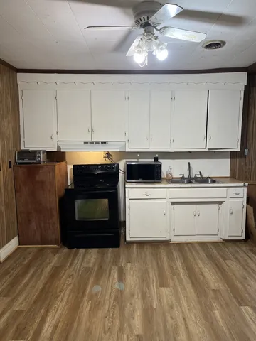 a kitchen with stainless steel appliances granite countertop a stove sink and cabinets