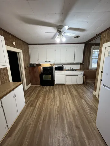 a large kitchen with a lot of counter space and stainless steel appliances