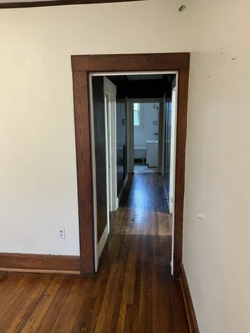 a view of a hallway with wooden floor
