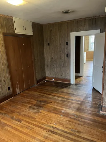 a view of a room with wooden floor