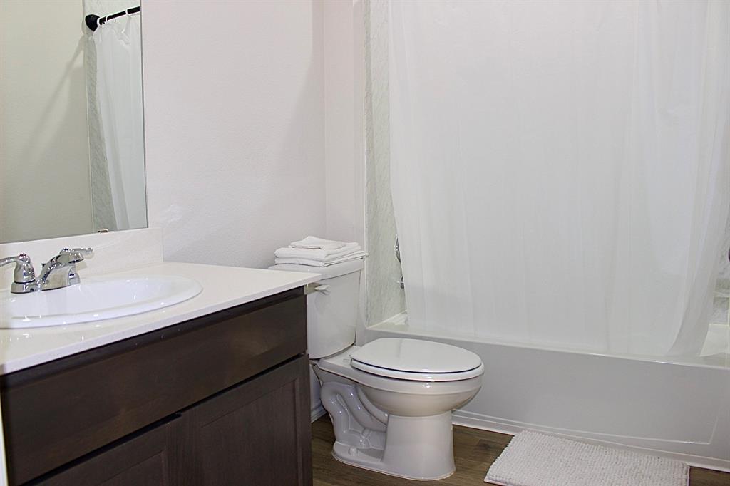 821 Country Road Royse City, TX 75189 - Photo 12 of 15 a bathroom with a sink a toilet and a mirror