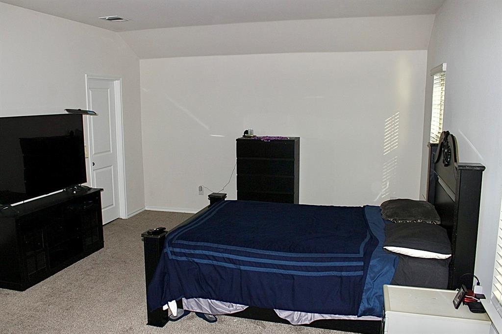 821 Country Road Royse City, TX 75189 - Photo 8 of 15 a bedroom with a bed and wooden floor