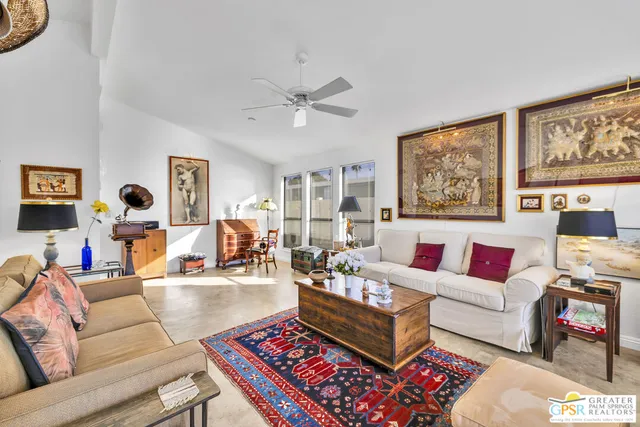 a living room with furniture a rug and a window