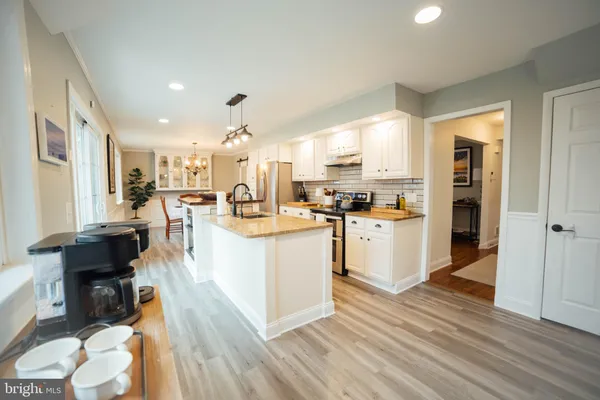 a kitchen with a refrigerator a sink and cabinets
