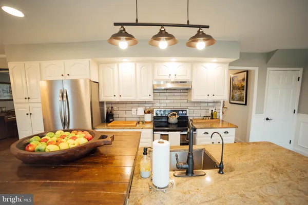 a large kitchen with granite countertop lots of counter top space