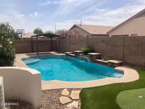 a living room with furniture and a dining table with kitchen view