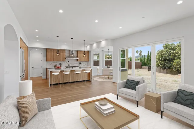 a kitchen with sink a large counter and appliances