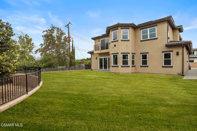 a view of yard with swimming pool and trees in the background