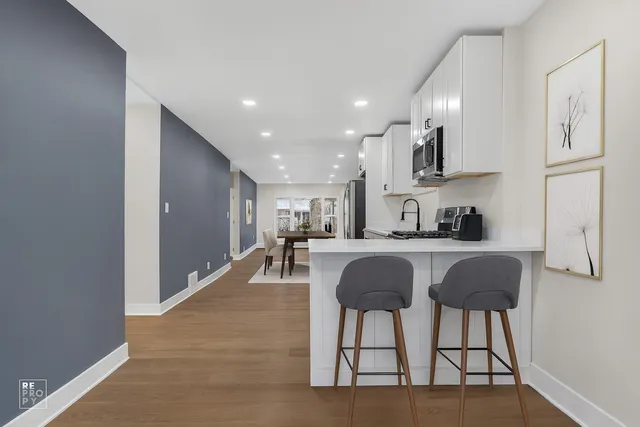 a kitchen with stainless steel appliances granite countertop a refrigerator and microwave