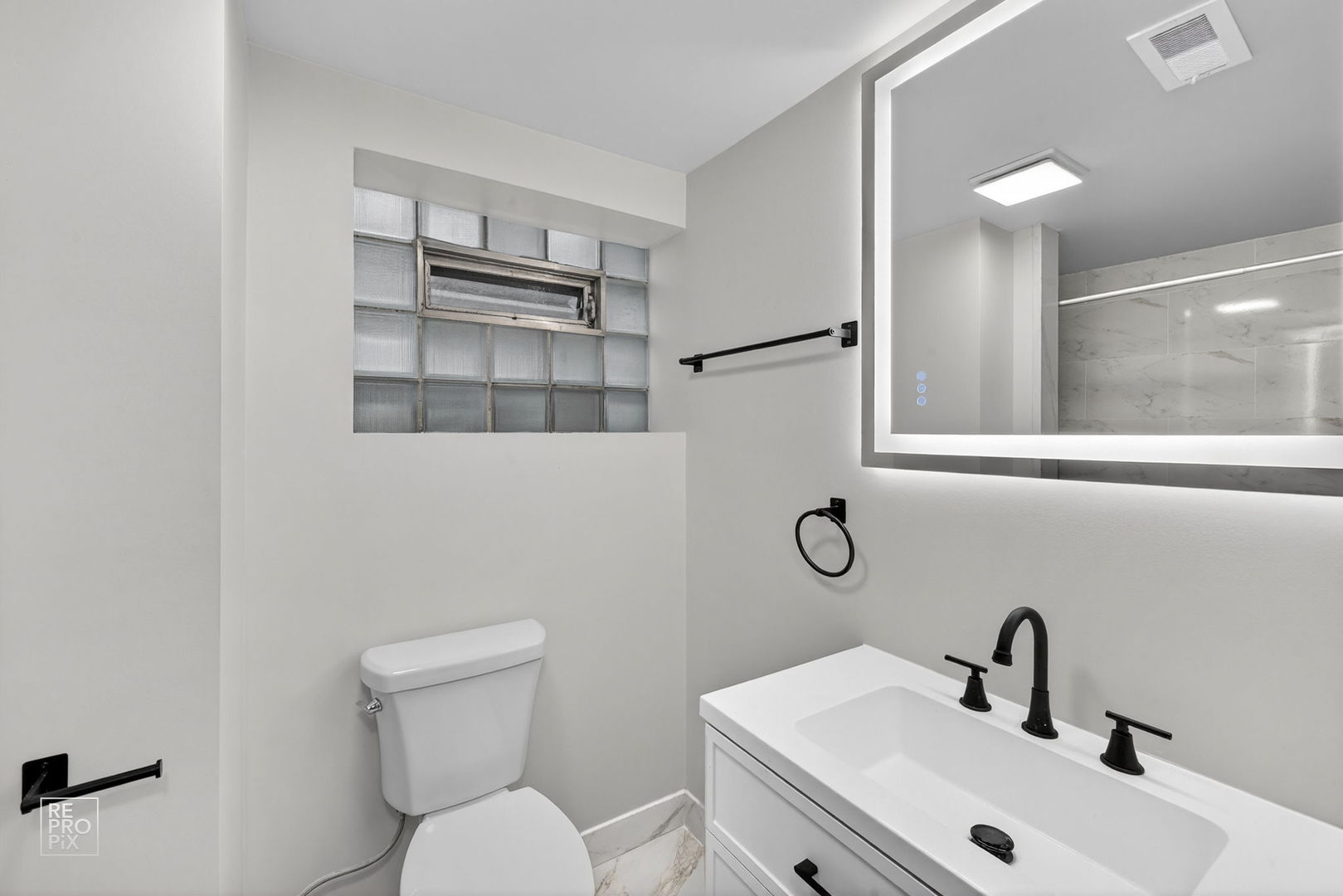 8420 South Carpenter Street Chicago, IL 60620 - Photo 16 of 23 a bathroom with a toilet a sink and mirror