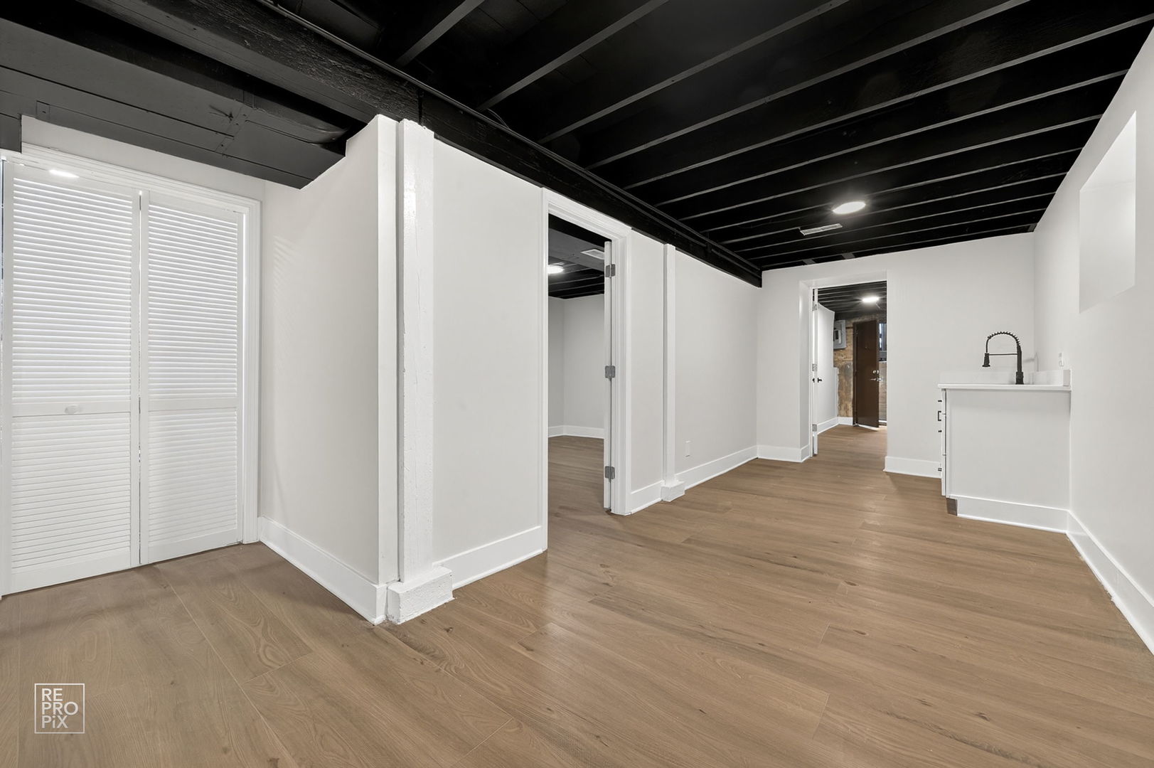 8420 South Carpenter Street Chicago, IL 60620 - Photo 19 of 23 a view of an empty room with wooden floor and a ceiling fan