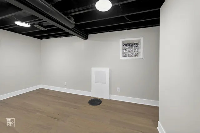 a view of a room with wooden floor