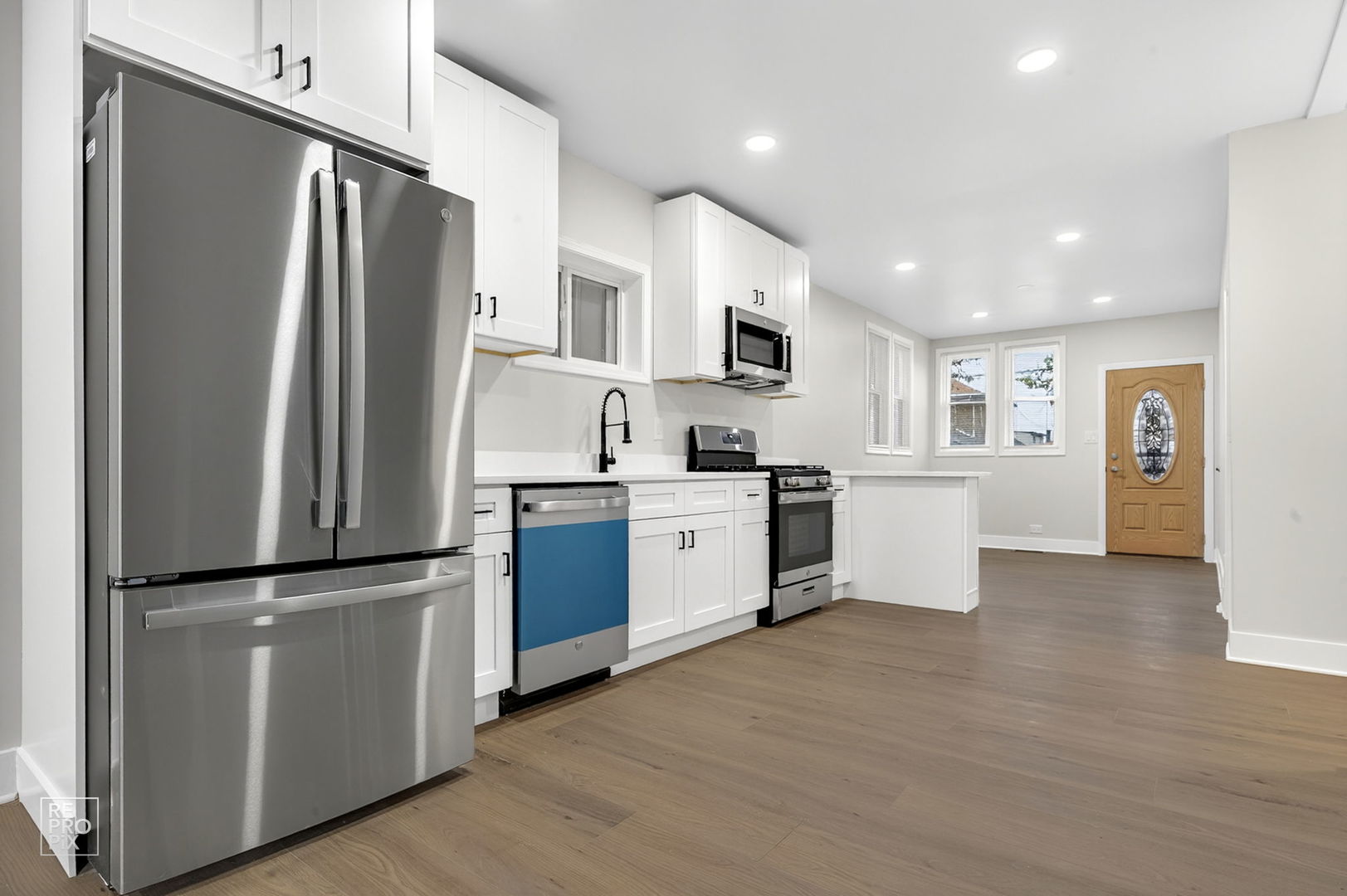 8420 South Carpenter Street Chicago, IL 60620 - Photo 5 of 23 a kitchen with stainless steel appliances a refrigerator sink and microwave