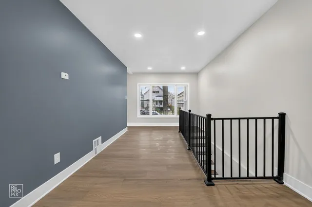 a view of gallery with wooden floor