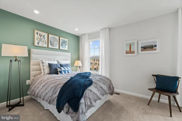 a bedroom with a bed and a chair