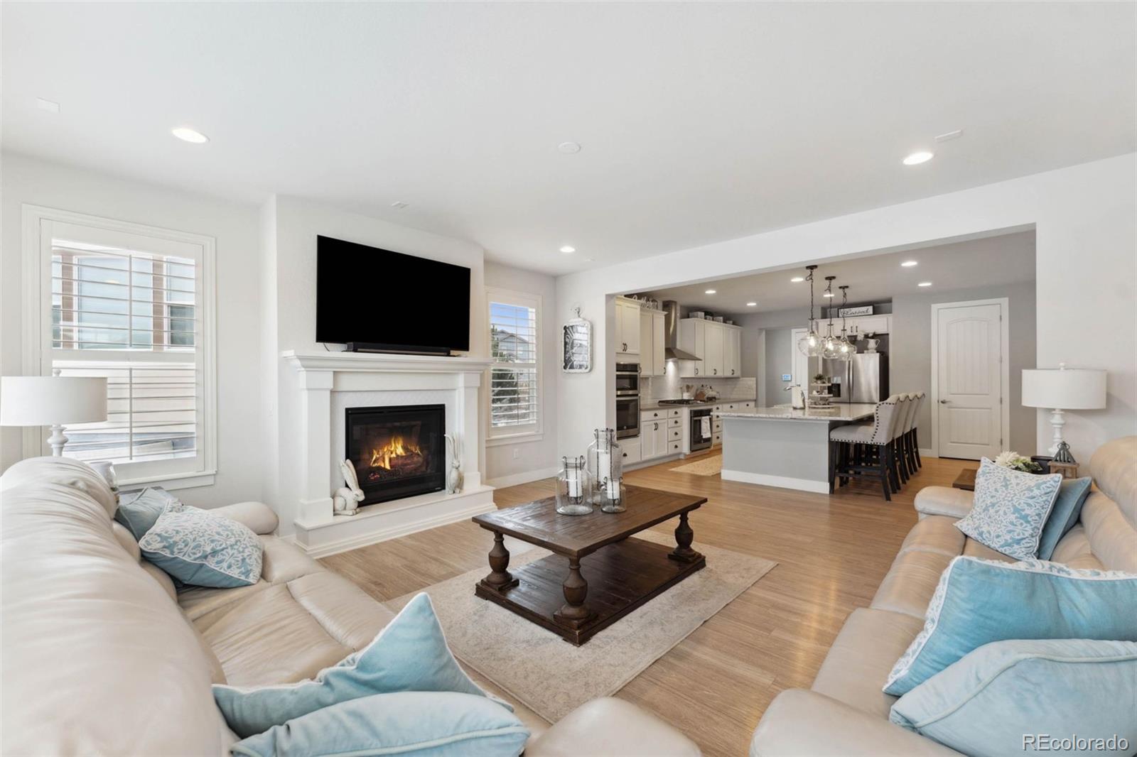 9459 Gore Loop Arvada, CO 80007 - Photo 12 of 50 a living room with furniture fireplace and flat screen tv