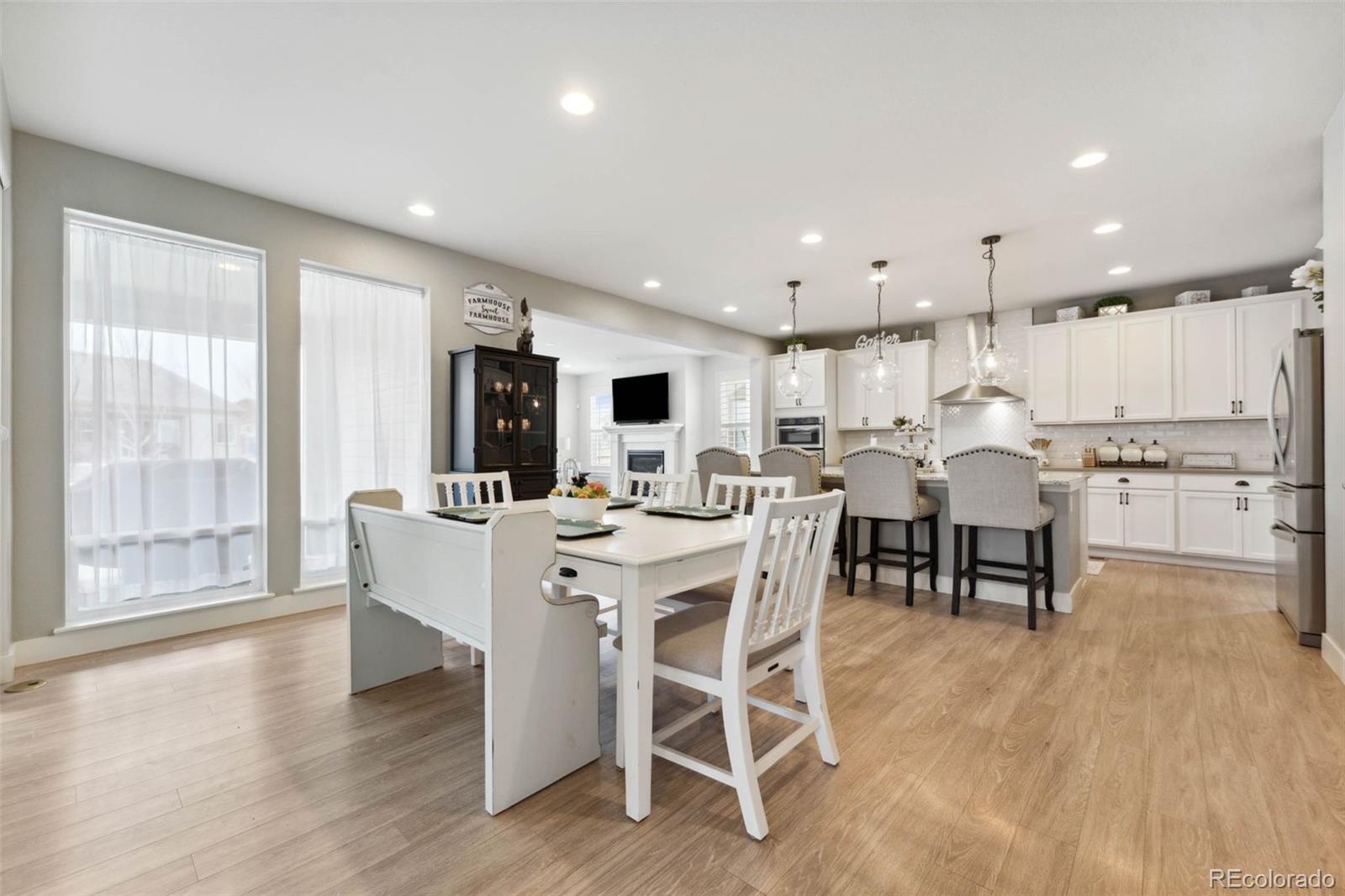 9459 Gore Loop Arvada, CO 80007 - Photo 17 of 50 a view of a dining room with furniture window and wooden floor